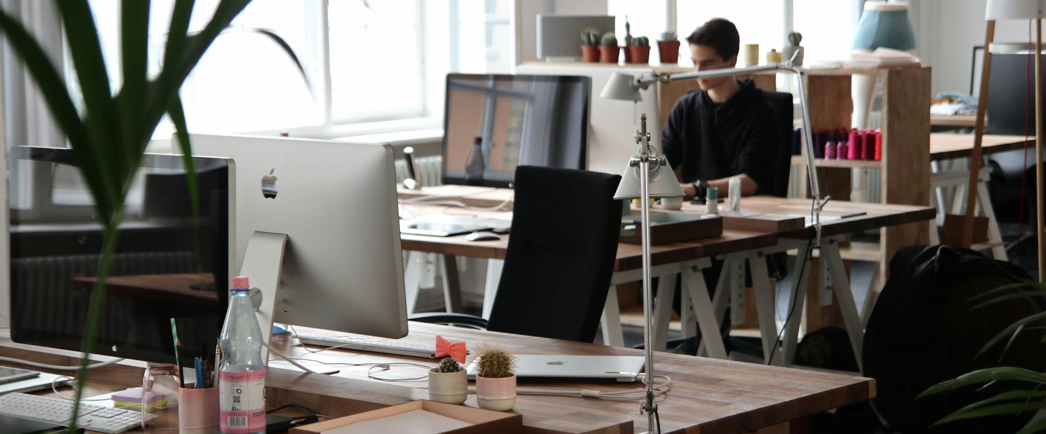 Open-plan office with modern decor and natural lighting, ideal for productivity.